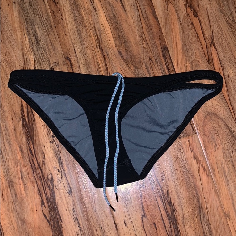 Jolyn swim bottoms with blue/purple draw string.
